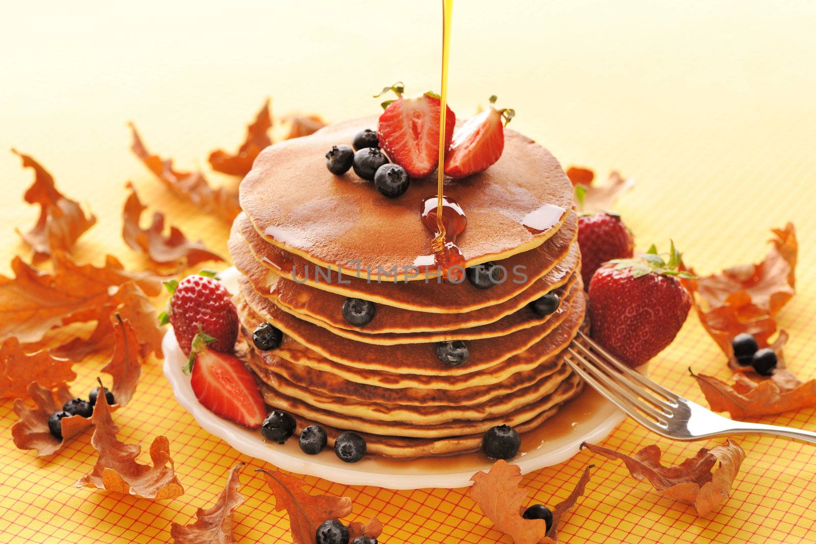 Delicious freshly prepared pancakes with strawberry and blueberries
