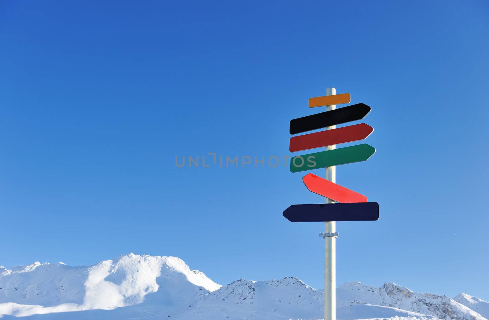 Arrow sign at mountains with snow in winter, Val-d'Isere, Alps, France