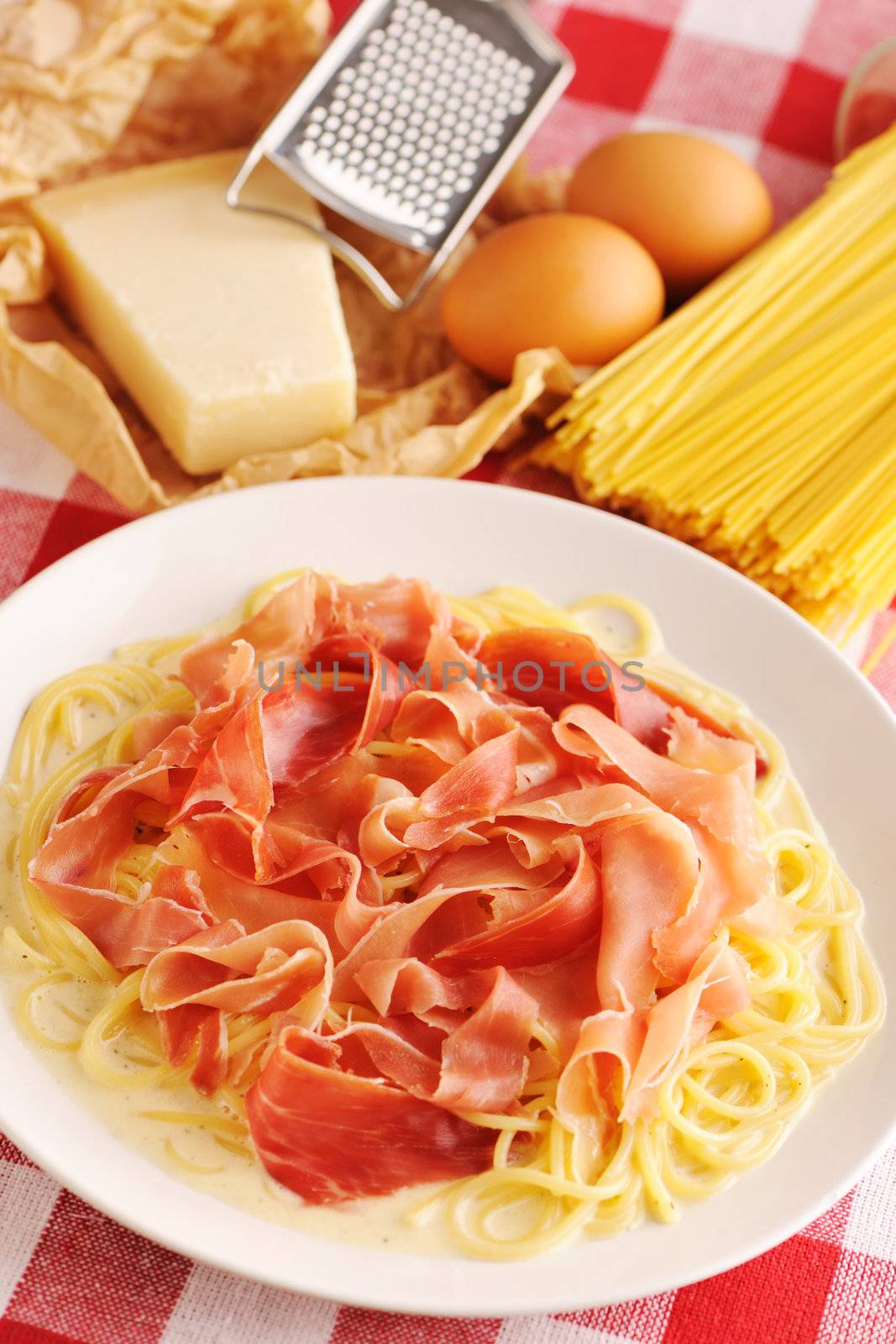 Pasta carbonara over red cloth