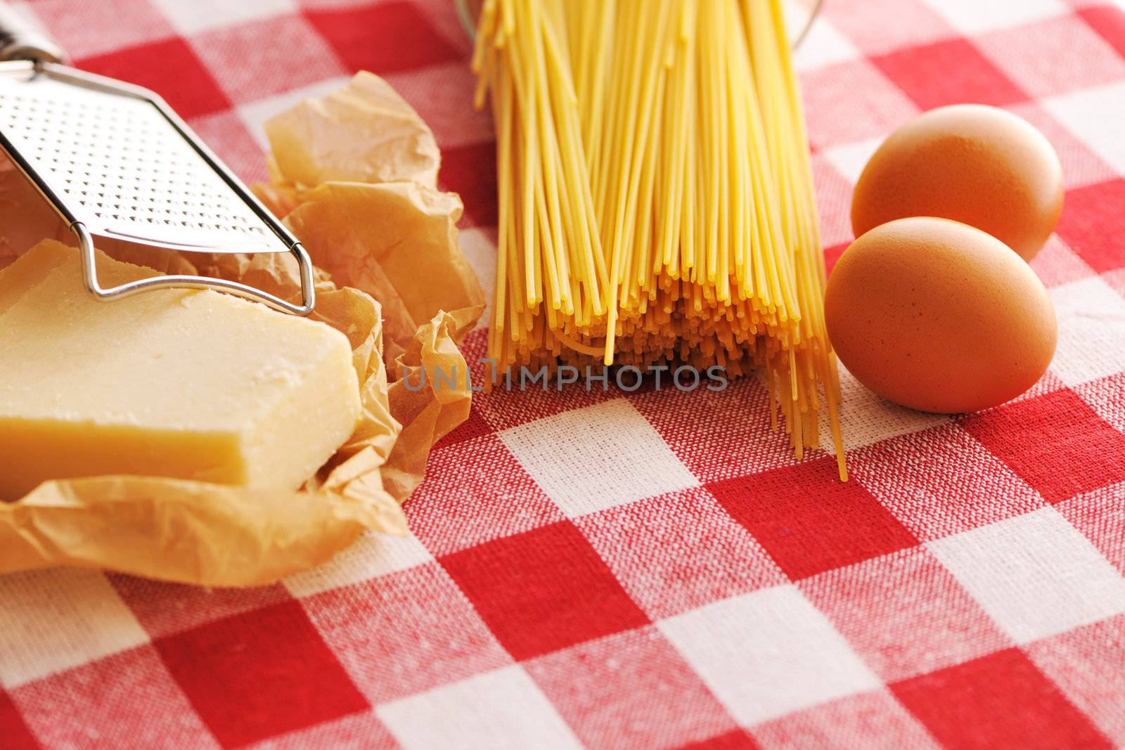 Pasta and ingredients over red cloth