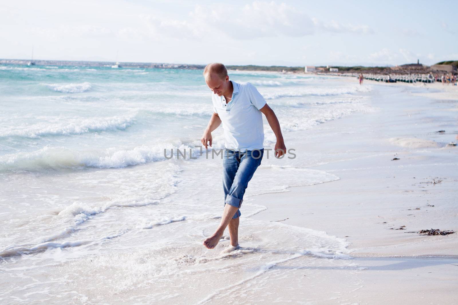 young man is relaxing on beach in summer vacation by juniart