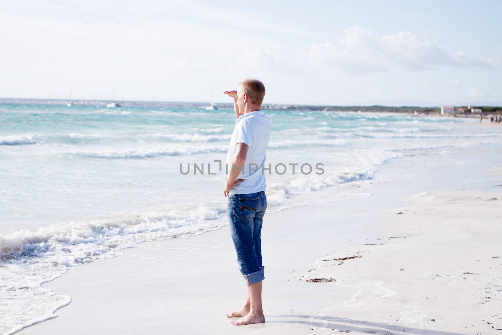 young man is relaxing on beach in summer vacation freedom