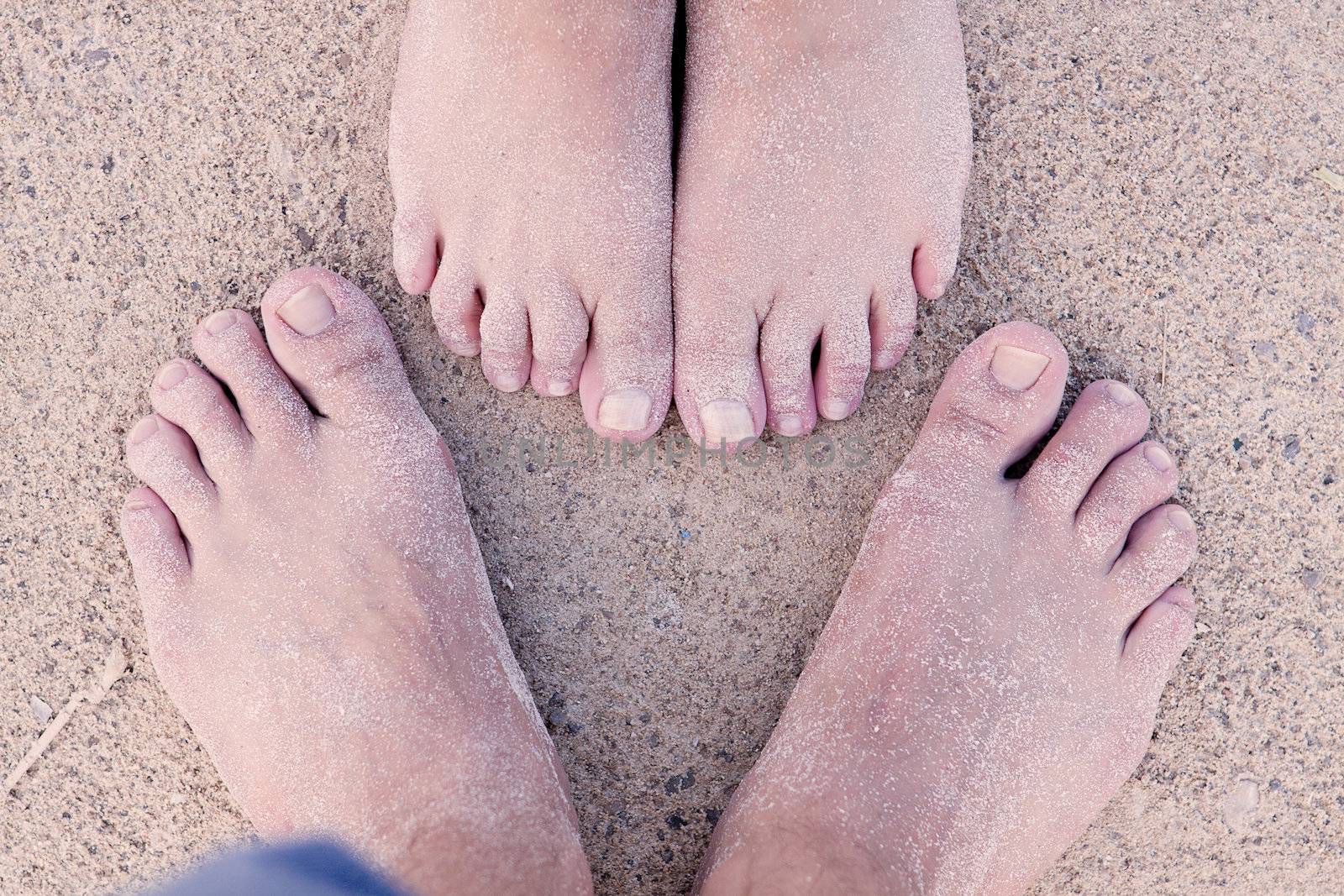 barefoot in sand and water on beach  in summer holidays relaxing