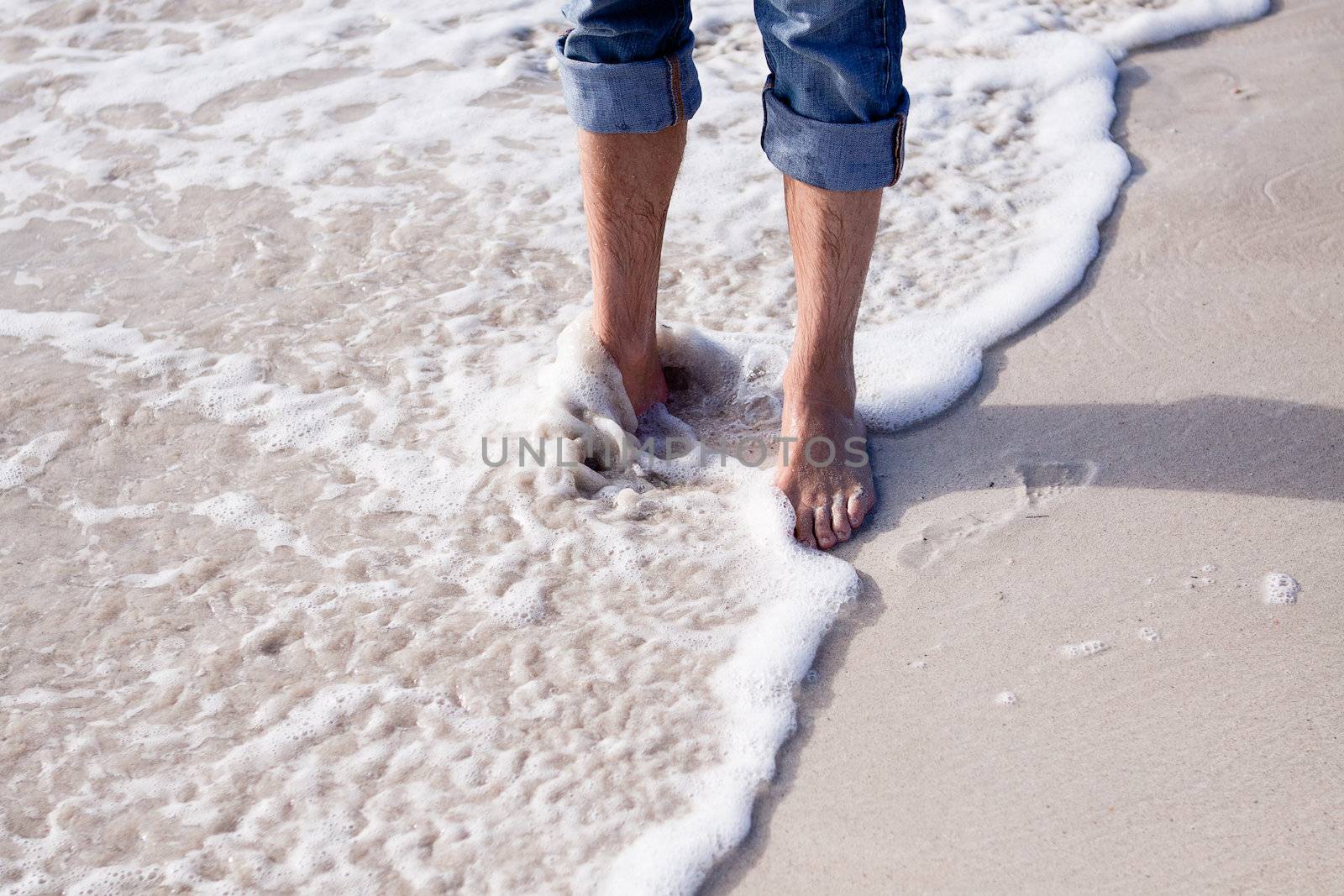 barefoot in sand and water on beach  in summer holidays relaxing