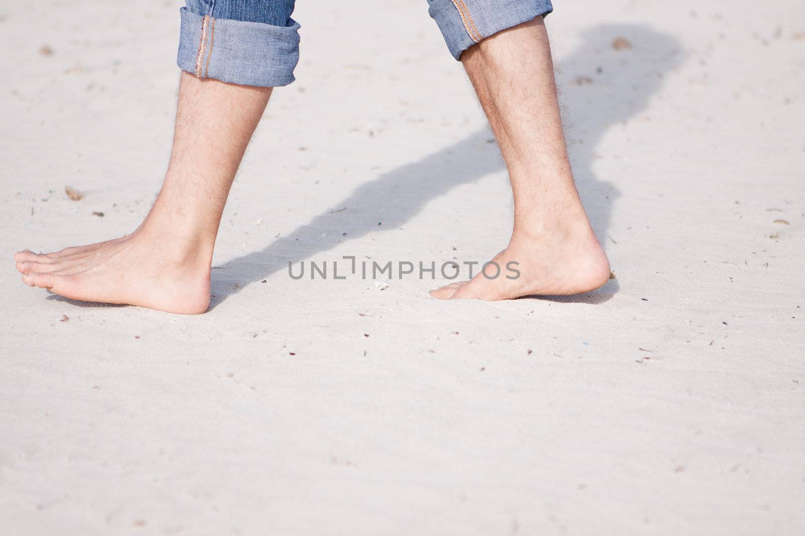 barefoot in sand and water on beach  in summer holidays relaxing