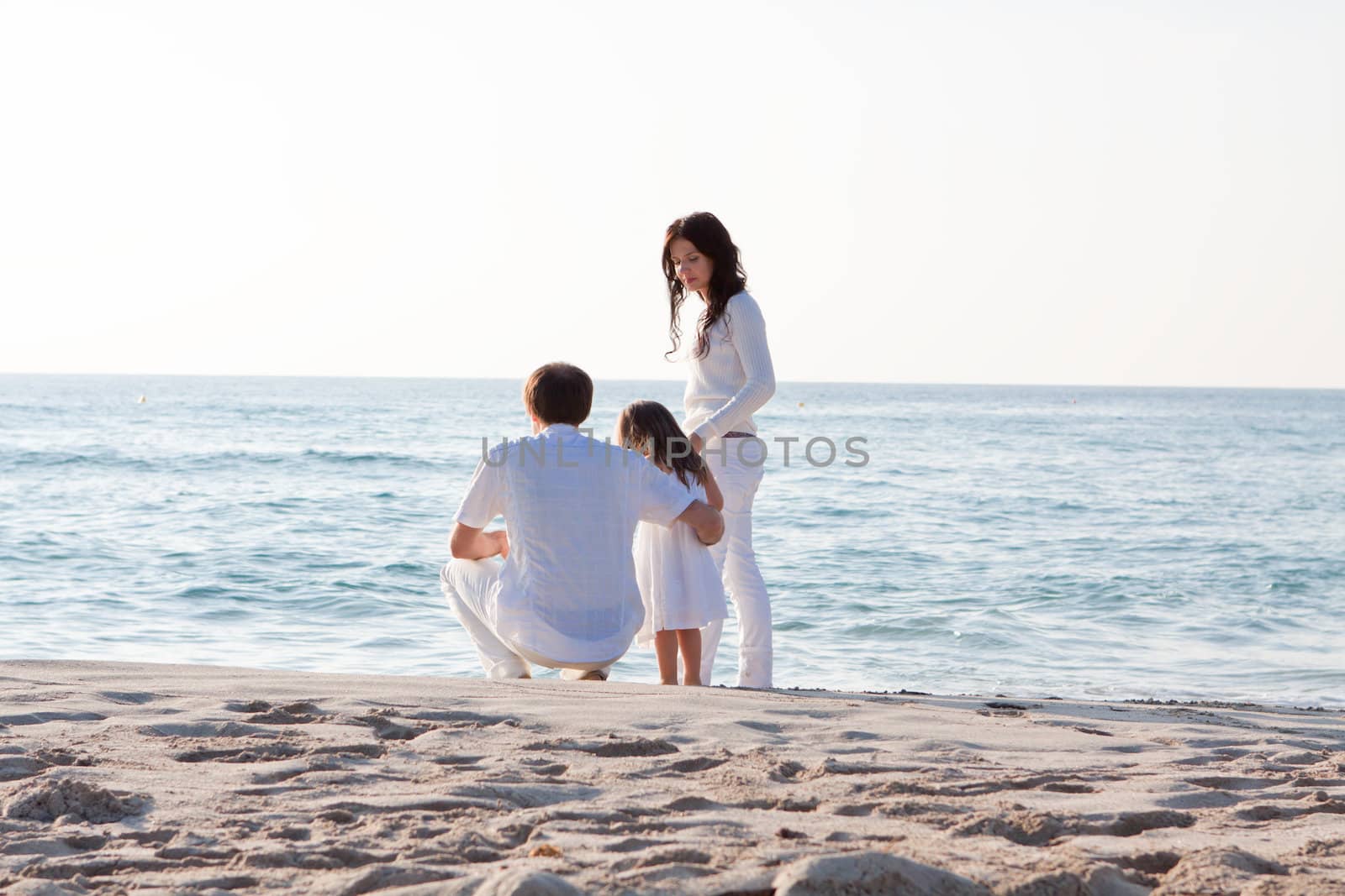 happy young family with daughter on beach in summer lifestyle