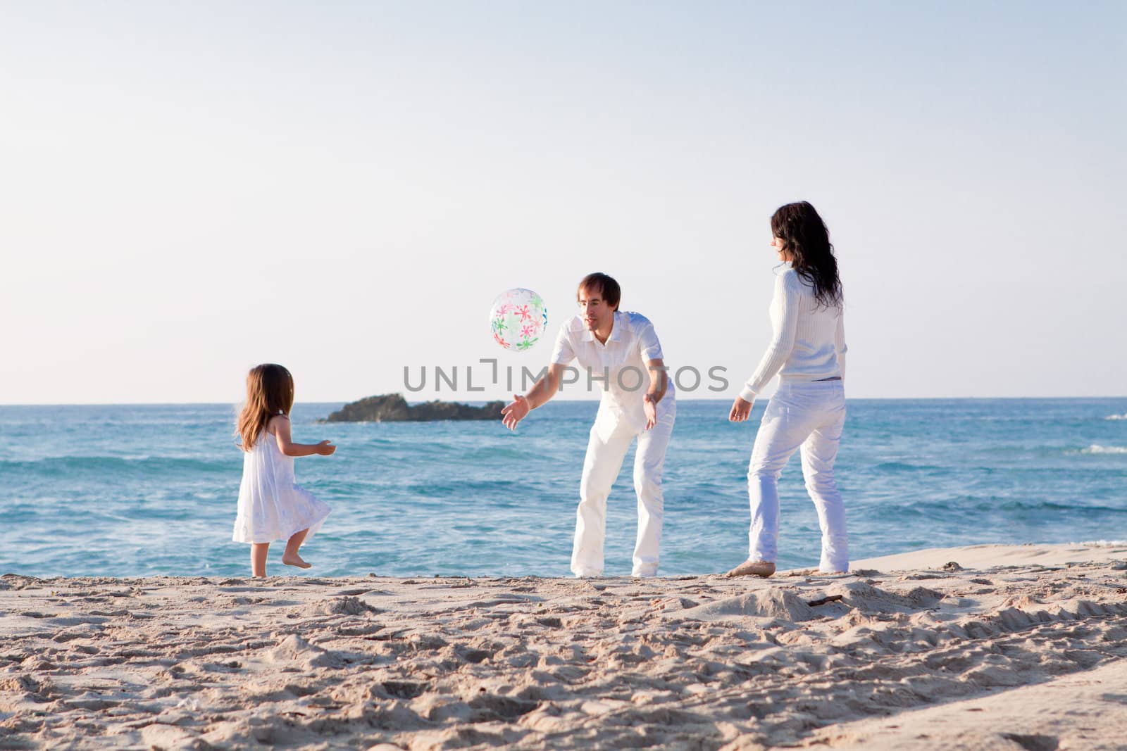 happy young family with daughter on beach in summer lifestyle