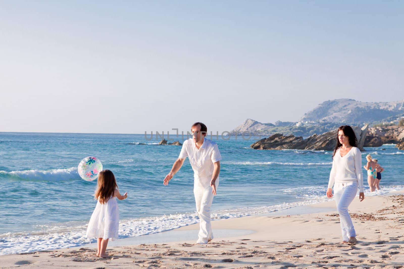 happy young family with daughter on beach in summer by juniart