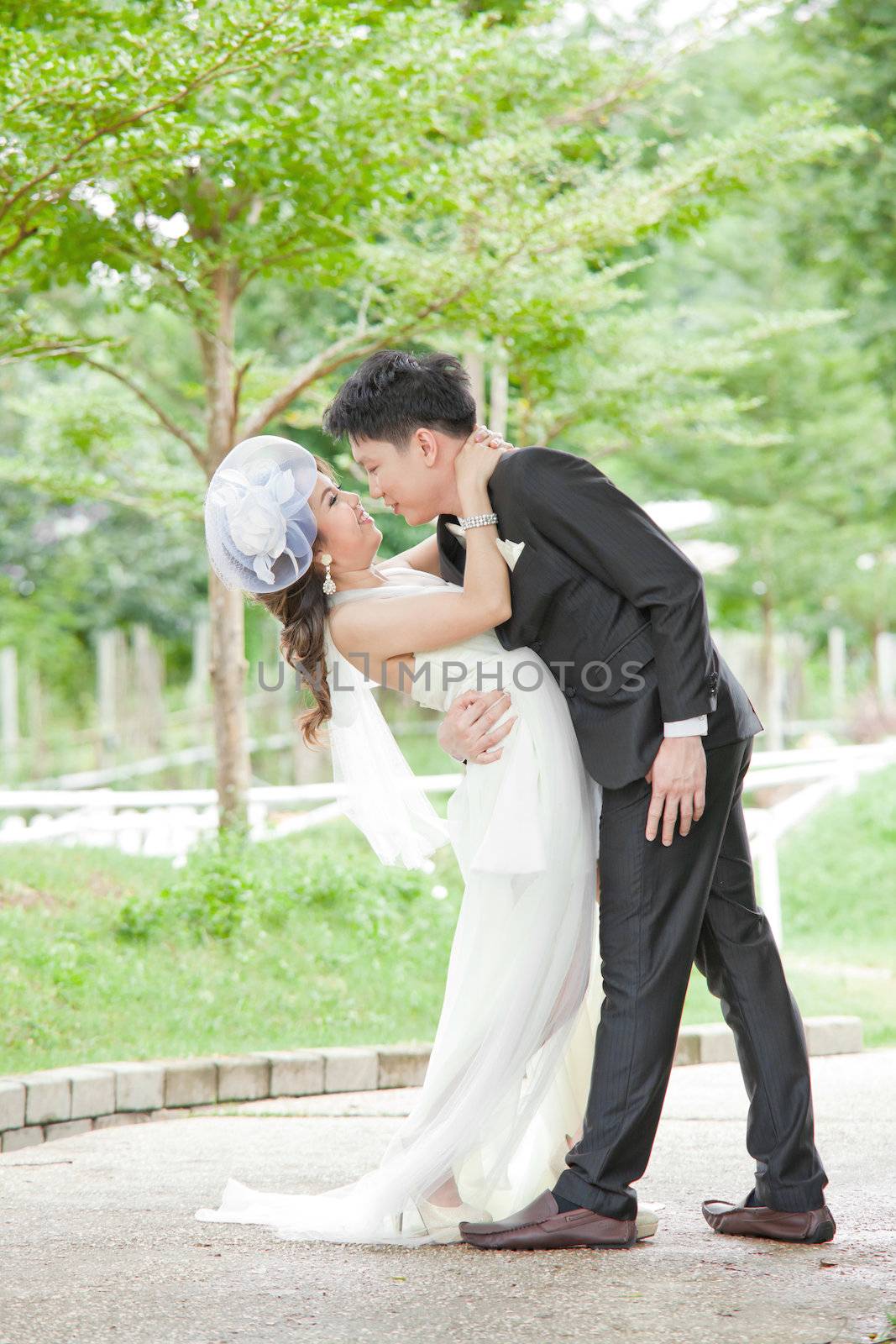 Portrait of Romantic Newlyweds Couples kissing for wedding background