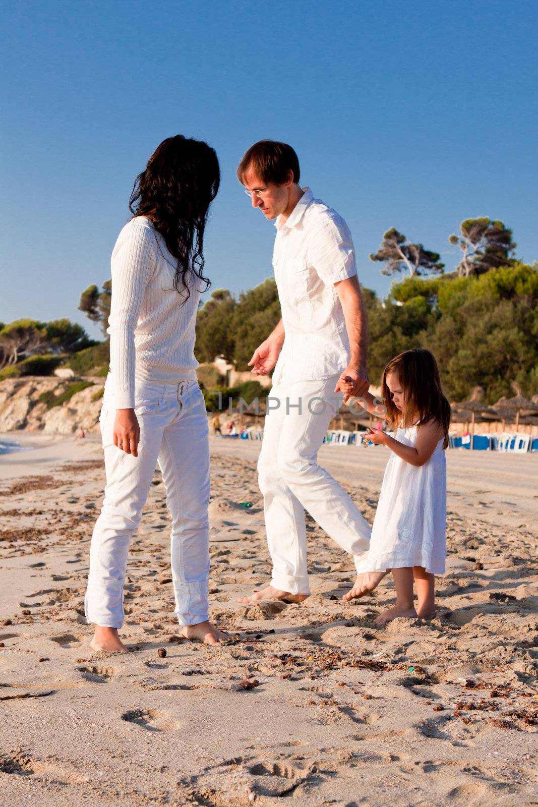 happy young family with daughter on beach in summer by juniart