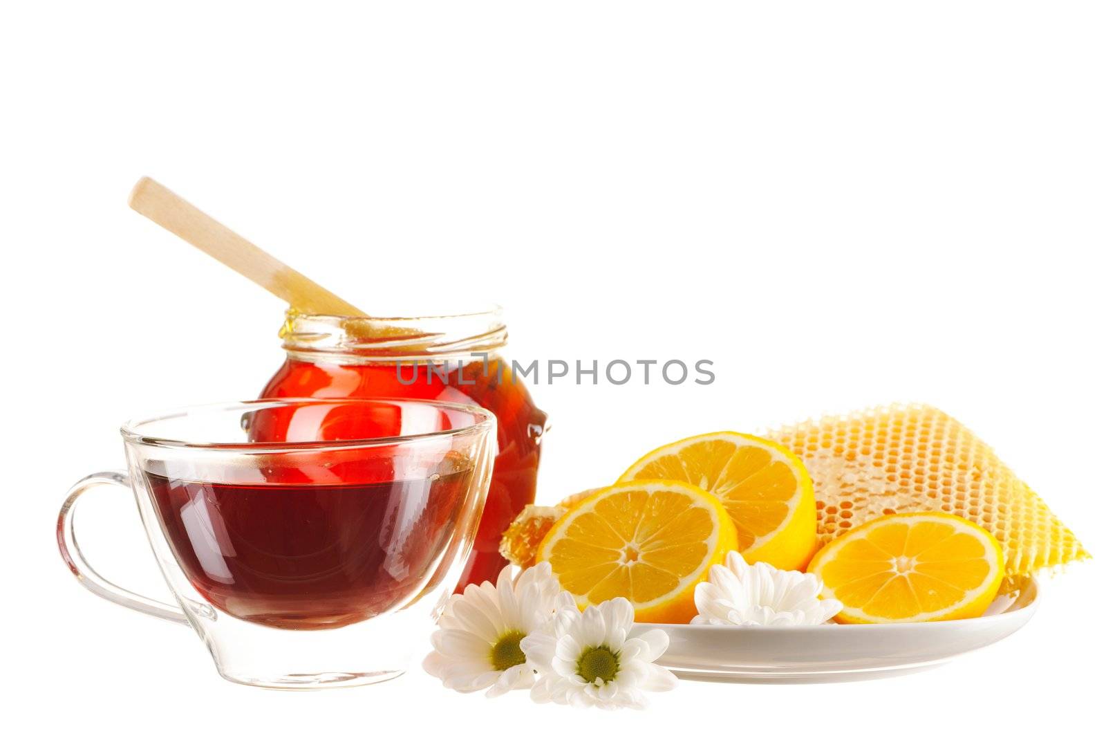 Jar of honey and tea cup isolated over white