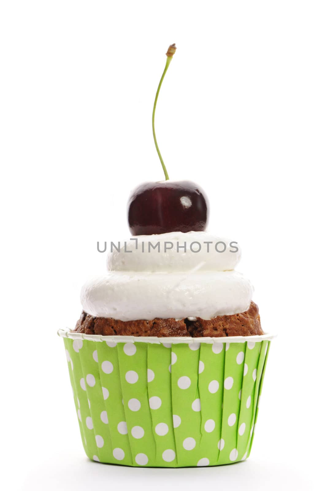 Cupcake with whipped cream and cherry isolated on white