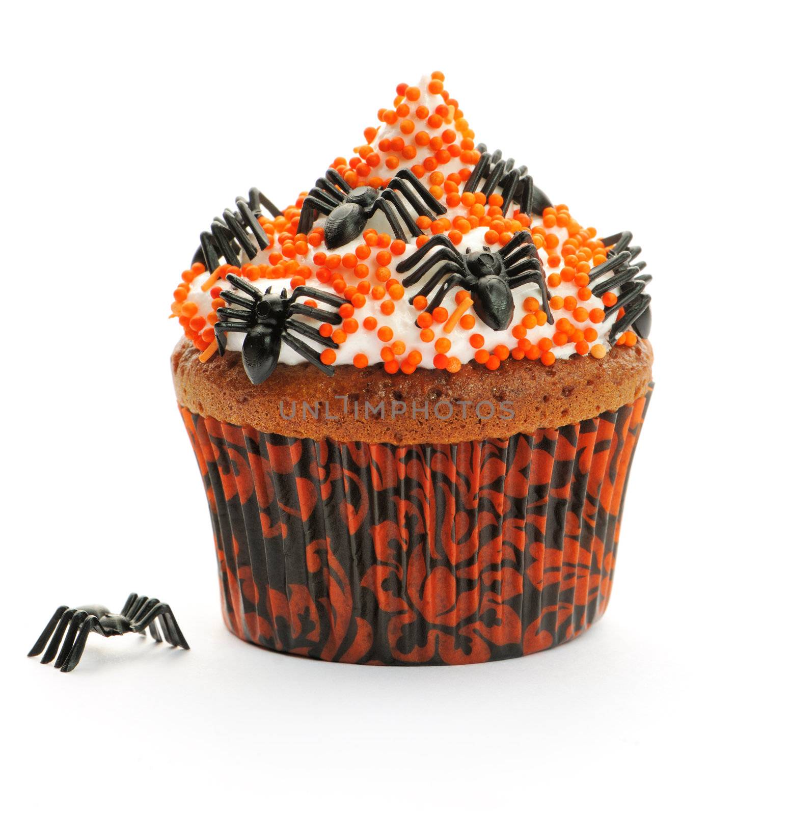 Halloween cupcake with whipped cream and decoration isolated on white