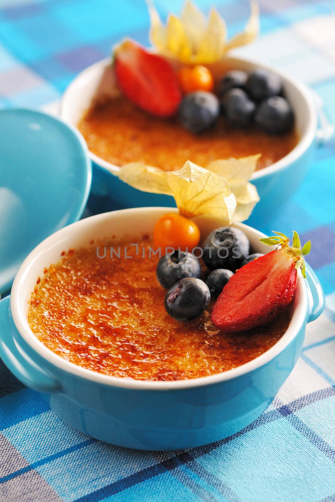 Creme brulee (cream brulee, burnt cream) with fruits and berries