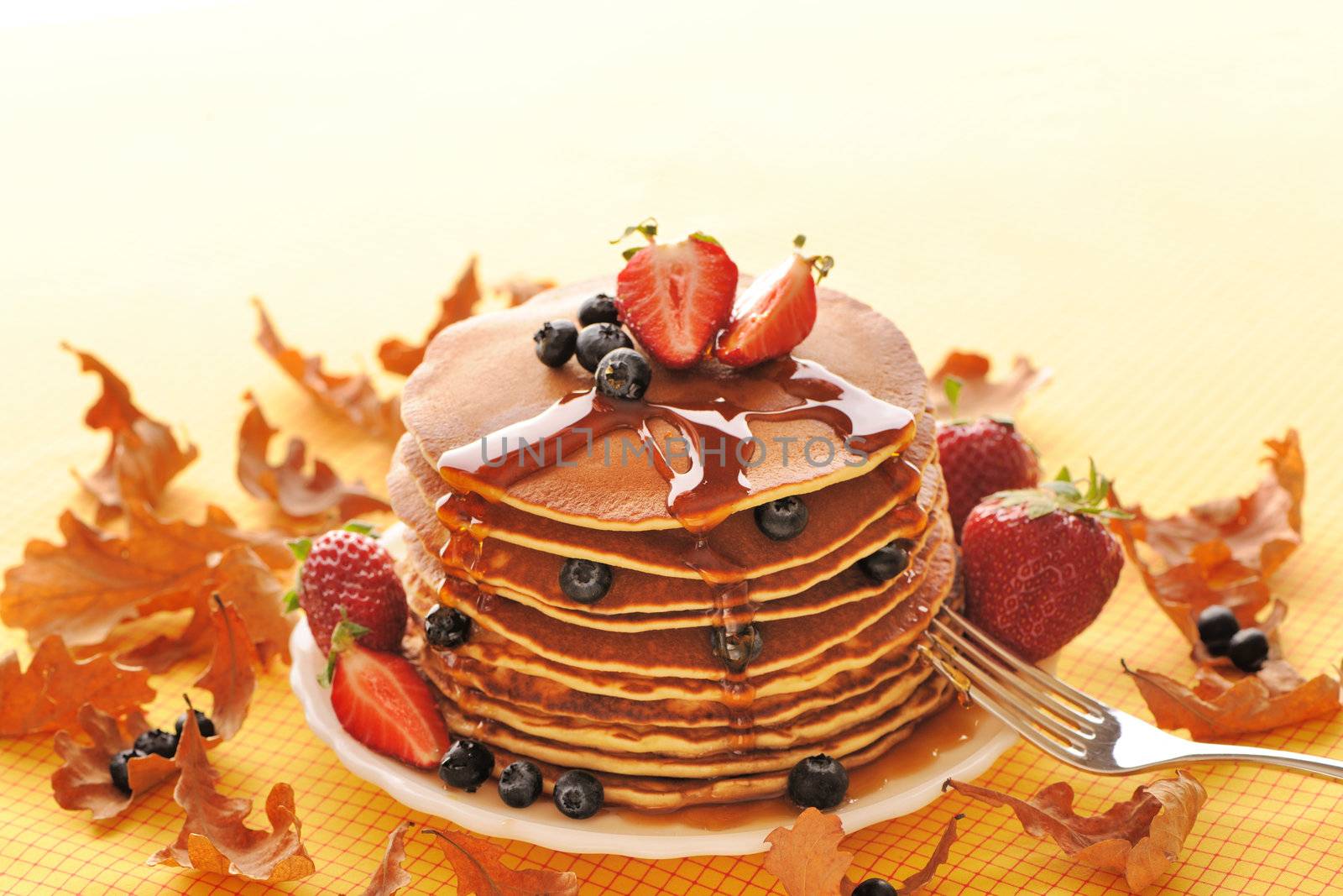 Delicious freshly prepared pancakes with strawberry and blueberries