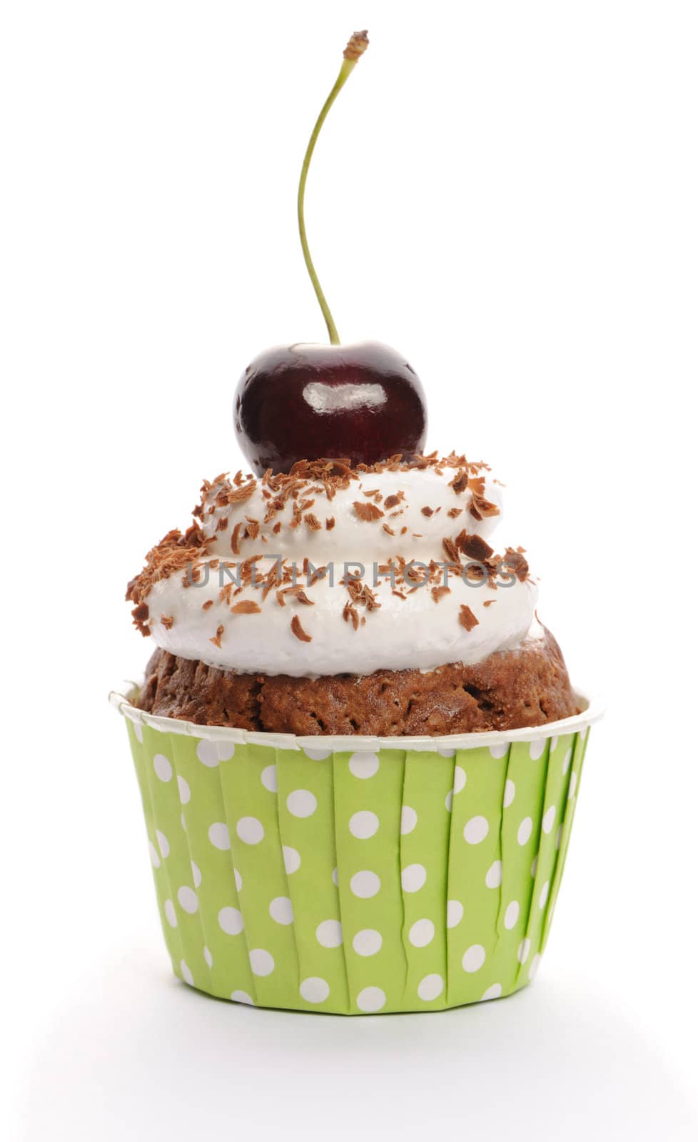 Cupcake with whipped cream and cherry isolated on white