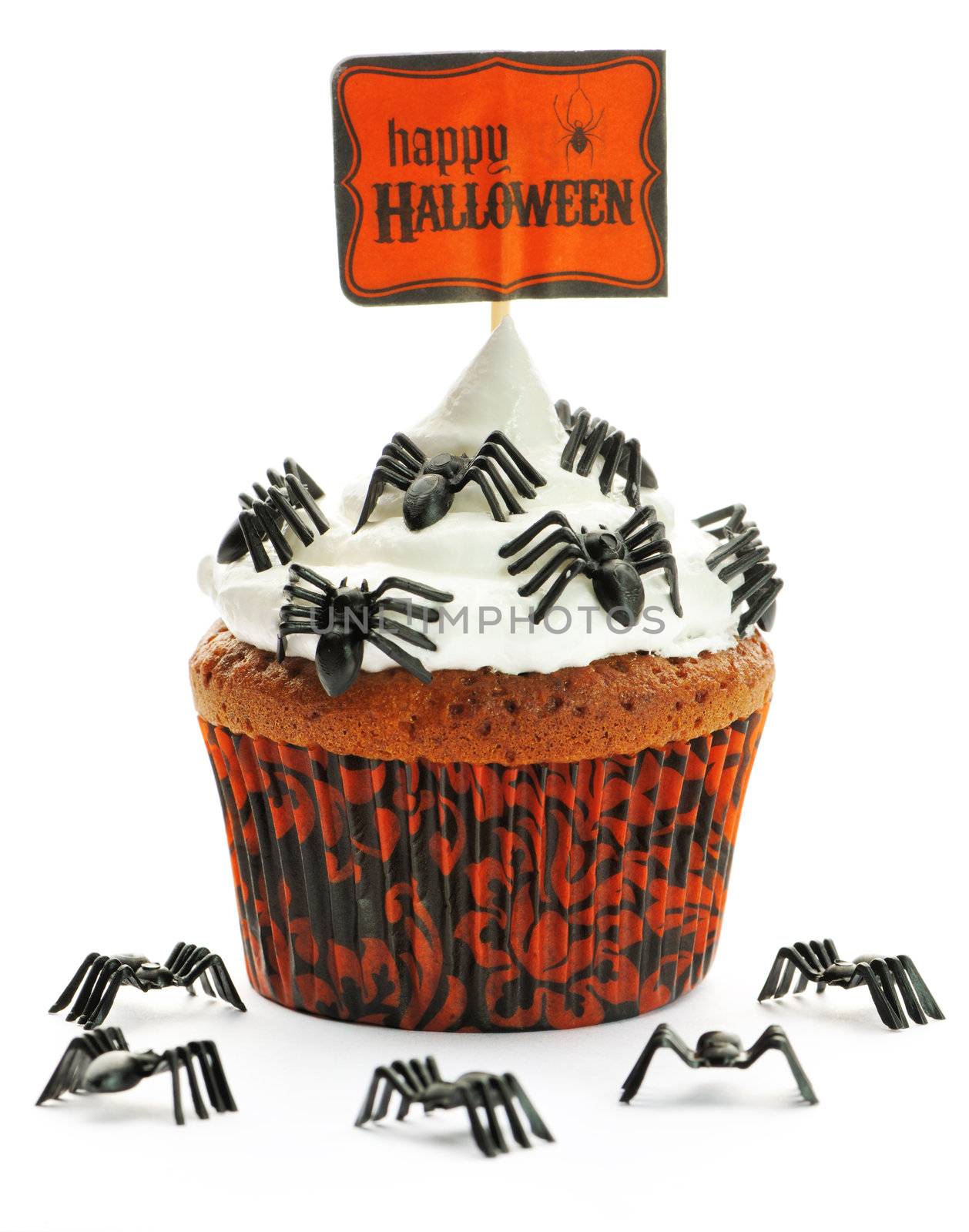 Halloween cupcake with whipped cream and decoration isolated on white