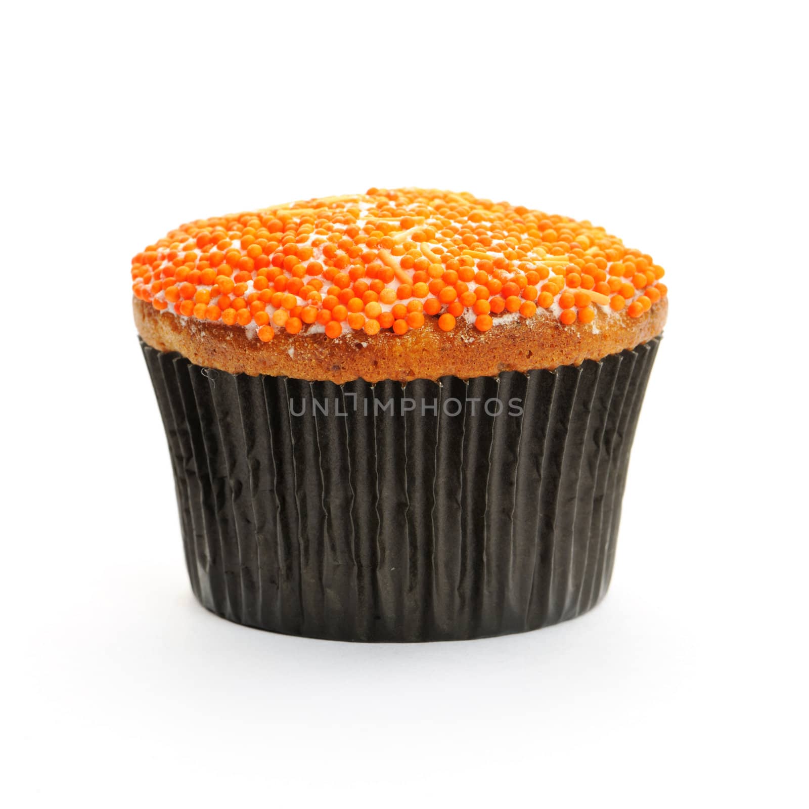 Cupcake with orange icing isolated on white