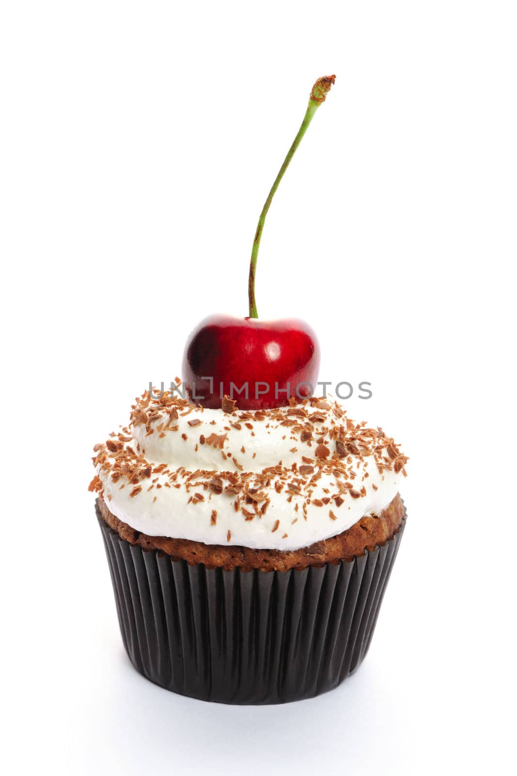 Cupcake with whipped cream and cherry isolated on white