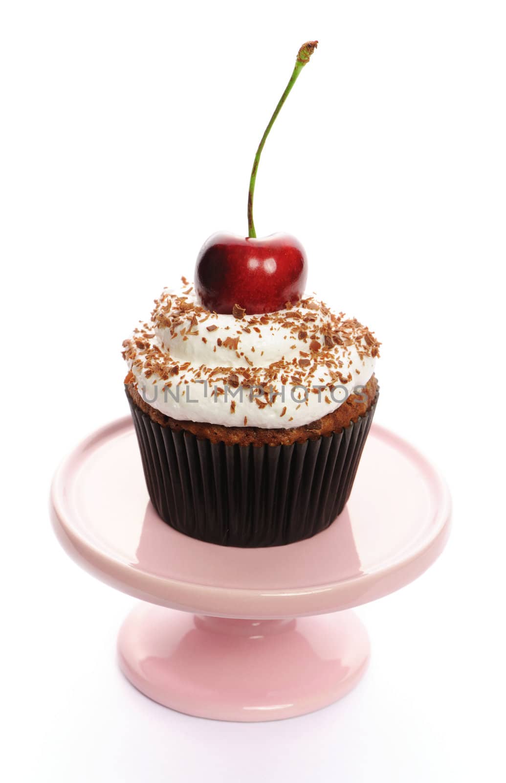 Cupcake with whipped cream and cherry isolated on white