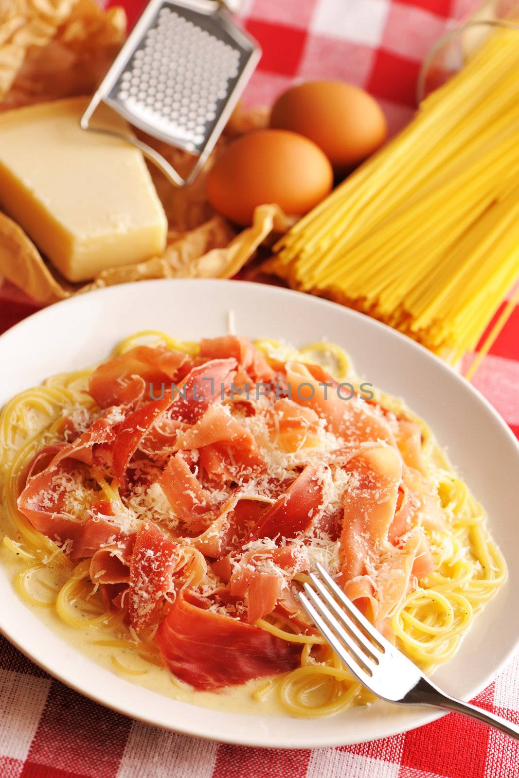 Pasta carbonara over red cloth