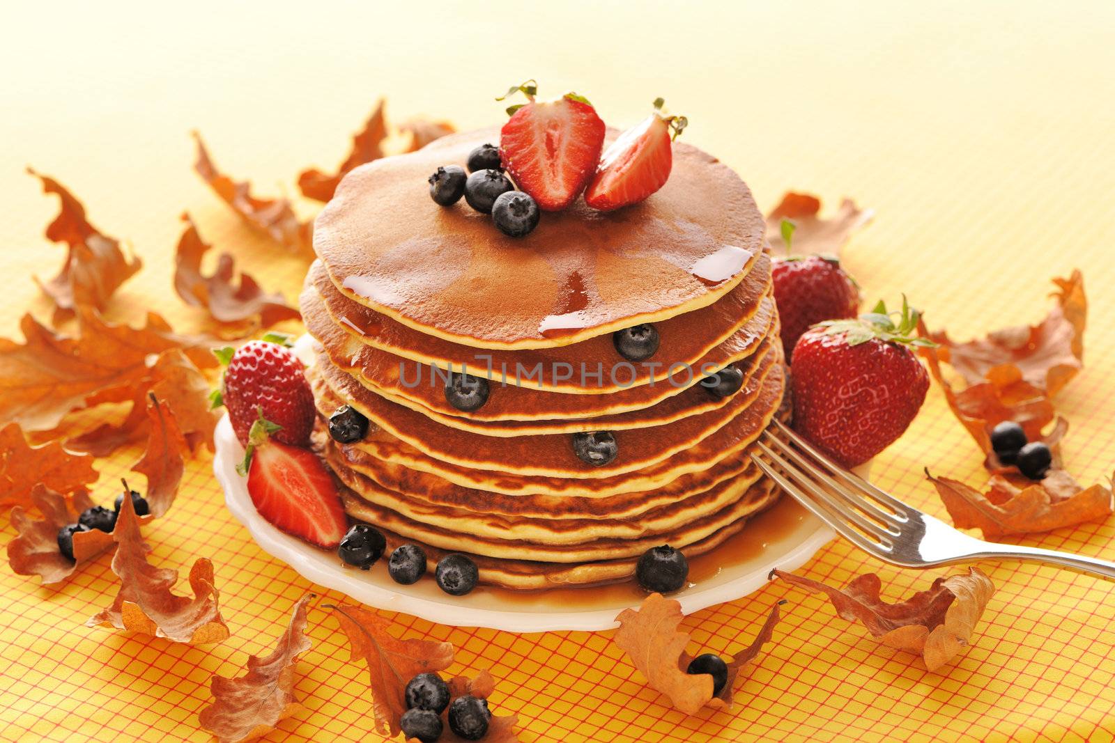 Delicious freshly prepared pancakes with strawberry and blueberries