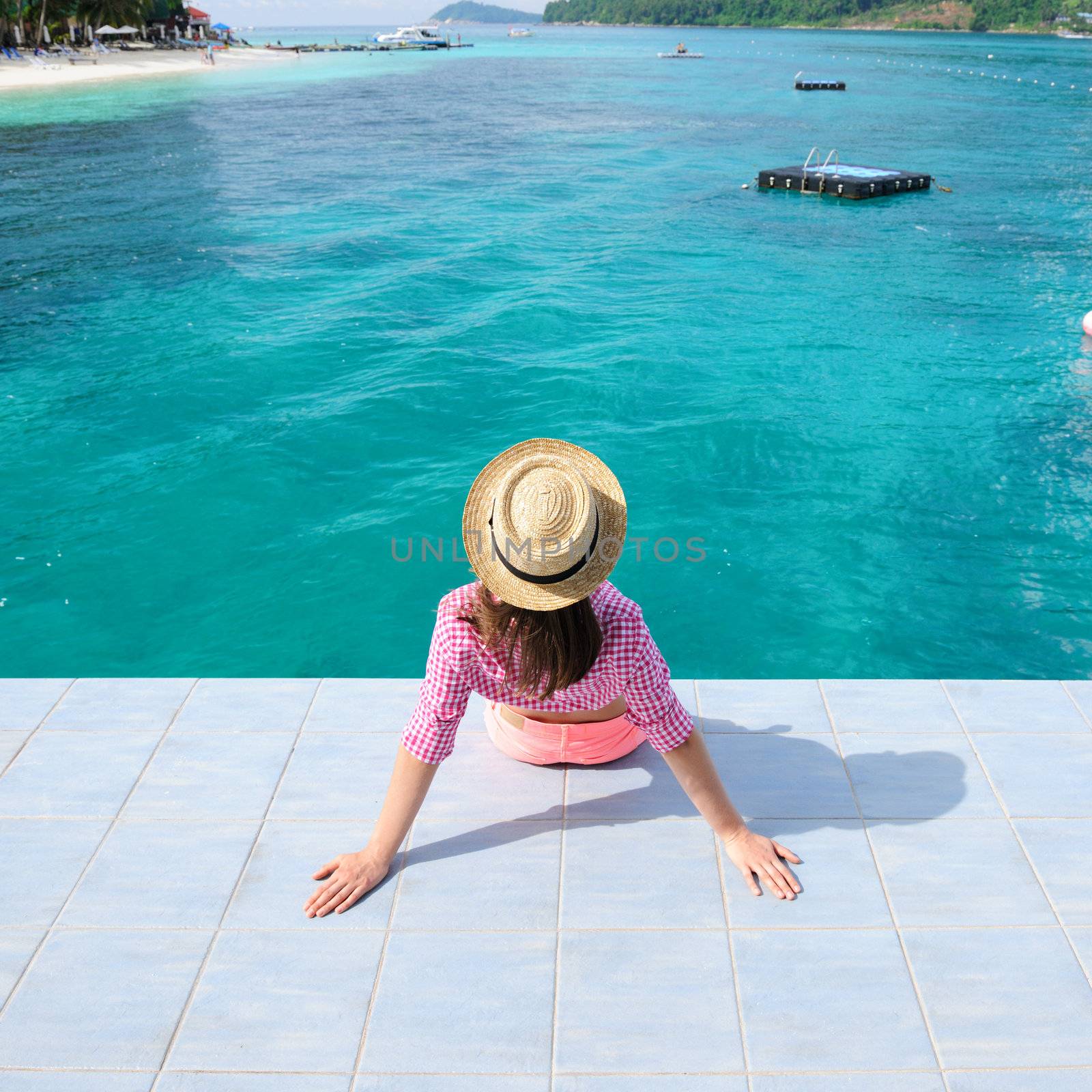 Woman at beach jetty by haveseen