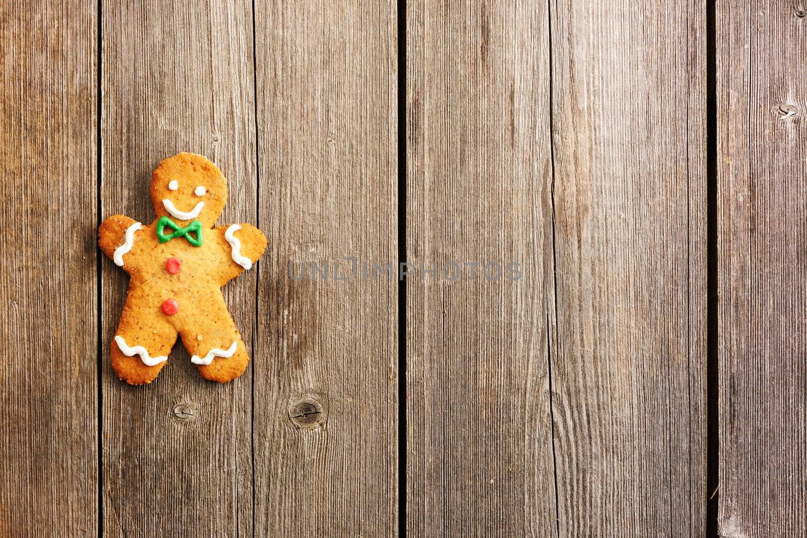 Christmas homemade gingerbread man over wooden table