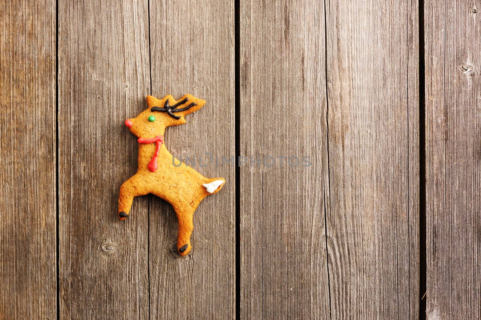 Christmas homemade gingerbread deer over wooden table