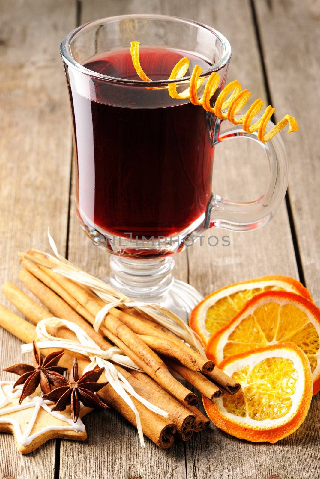 Glass of red mulled wine on wooden table