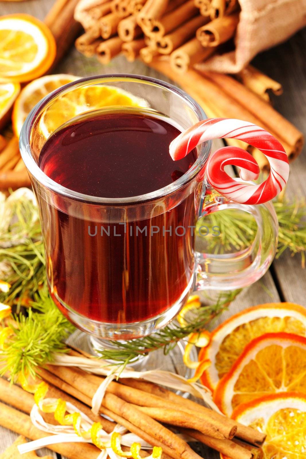 Glass of red mulled wine on wooden table