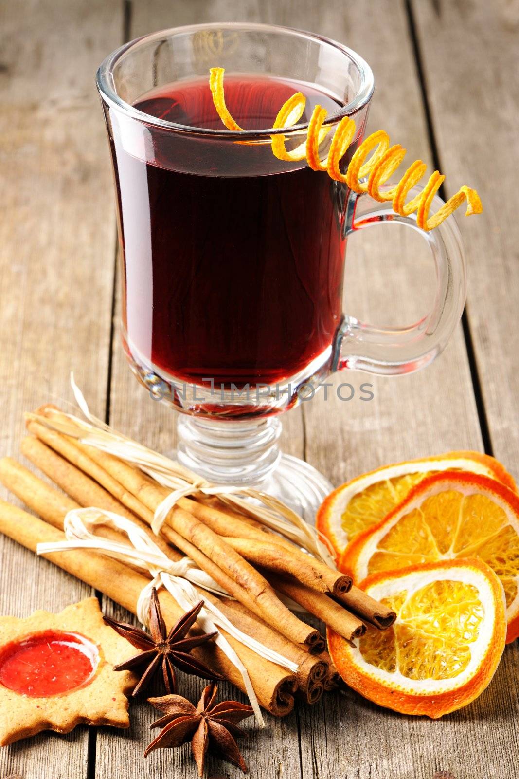 Glass of red mulled wine on wooden table