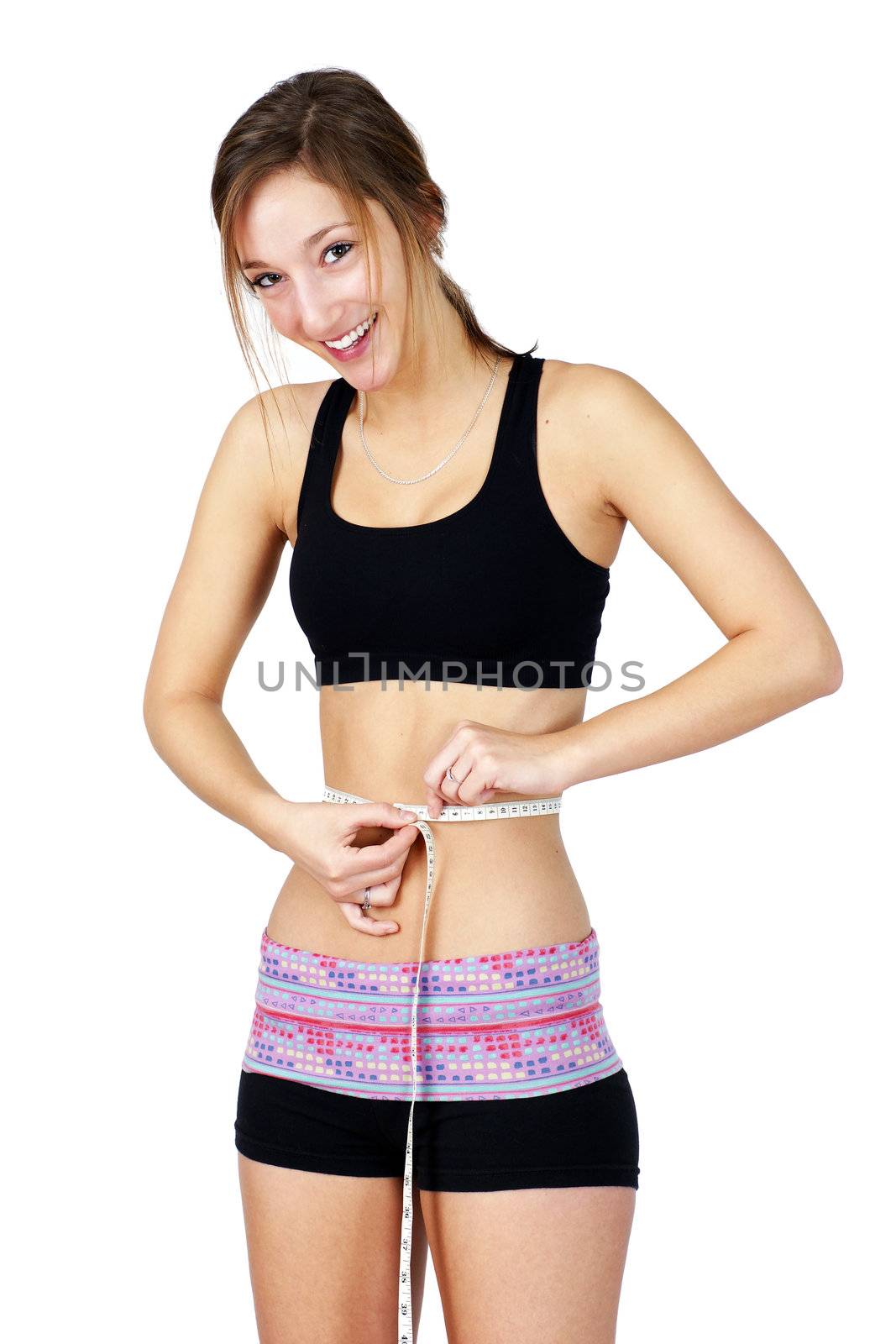 Pretty, sporty and fit young woman in work out clothes happy over waist measurements, perfect for health issues.