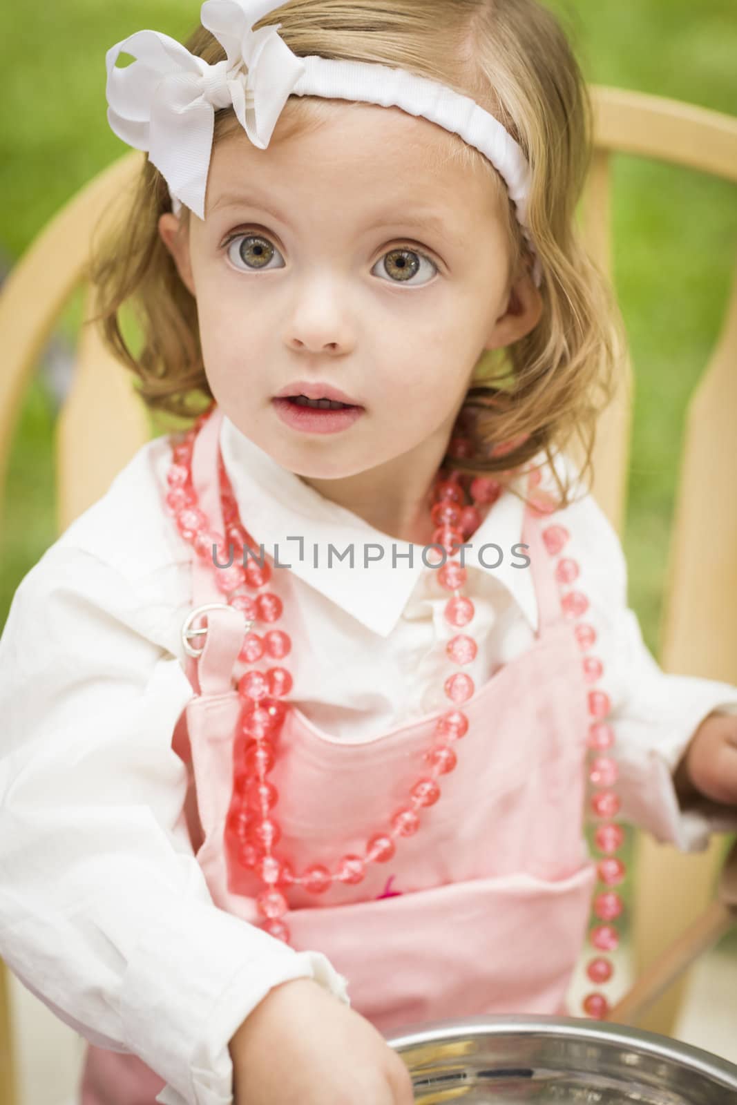 Happy Adorable Little Girl Playing Chef Cooking in Her Pink Outfit.