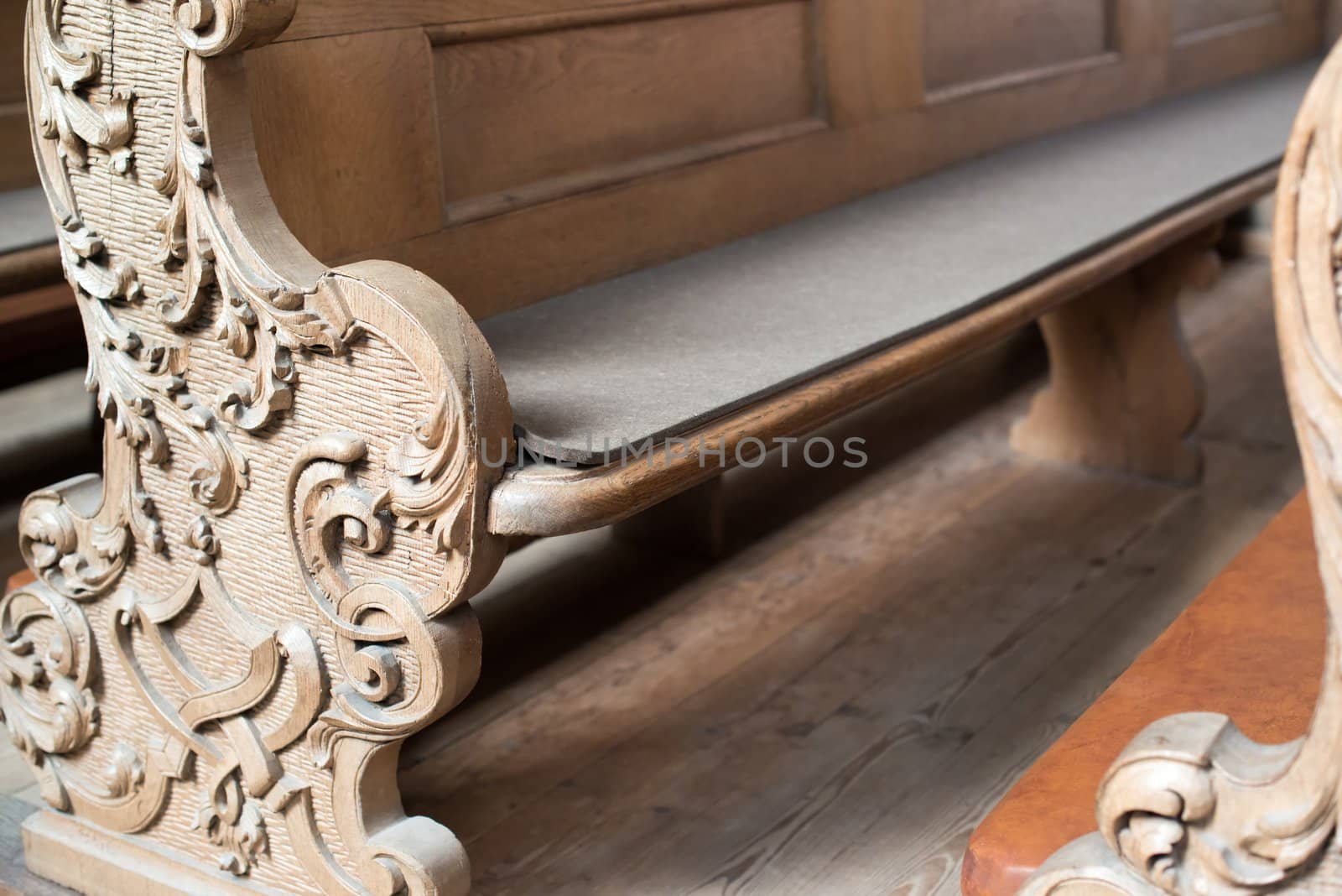 rows of beautifully decorated old wooden church benches