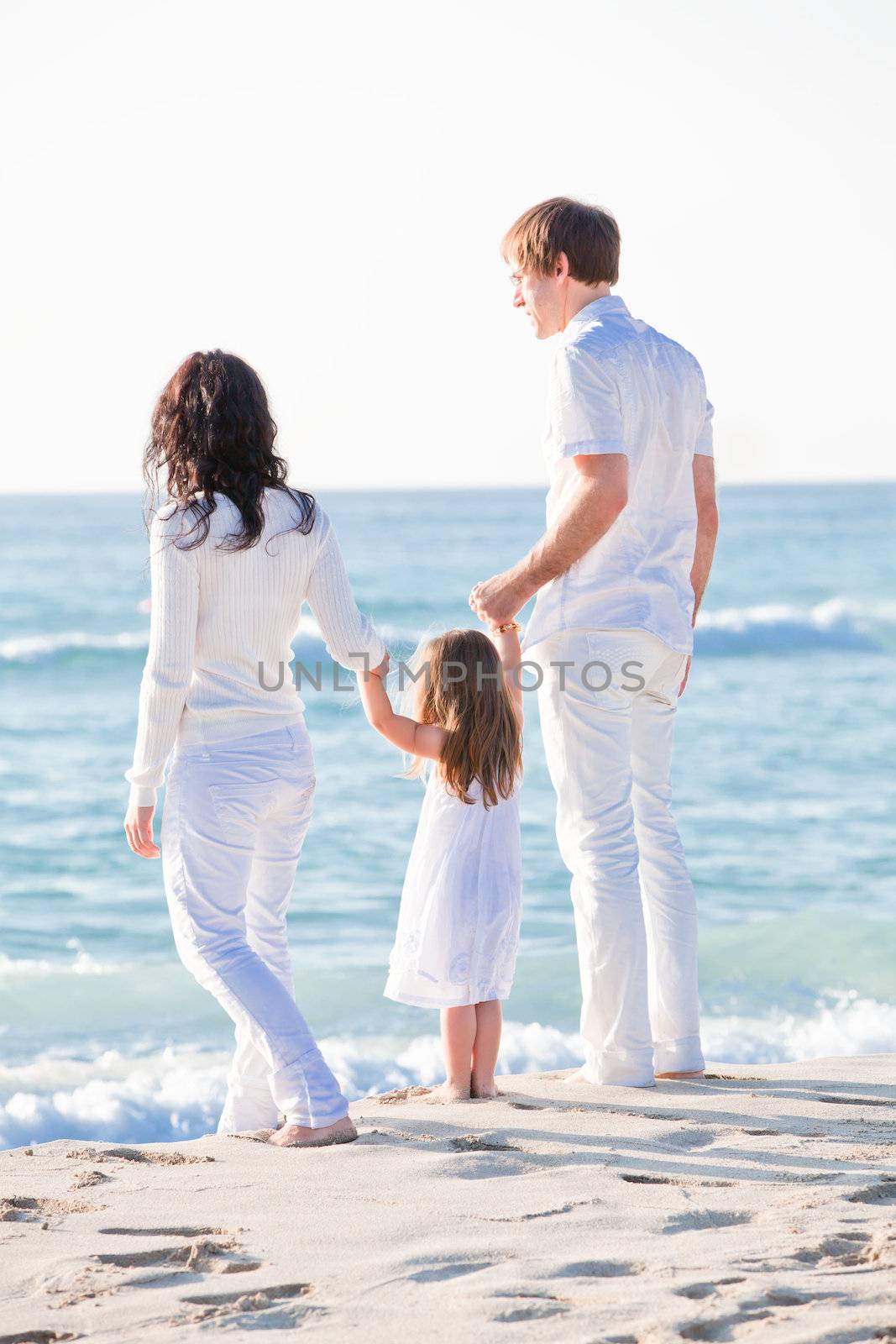 happy young family with daughter on beach in summer by juniart