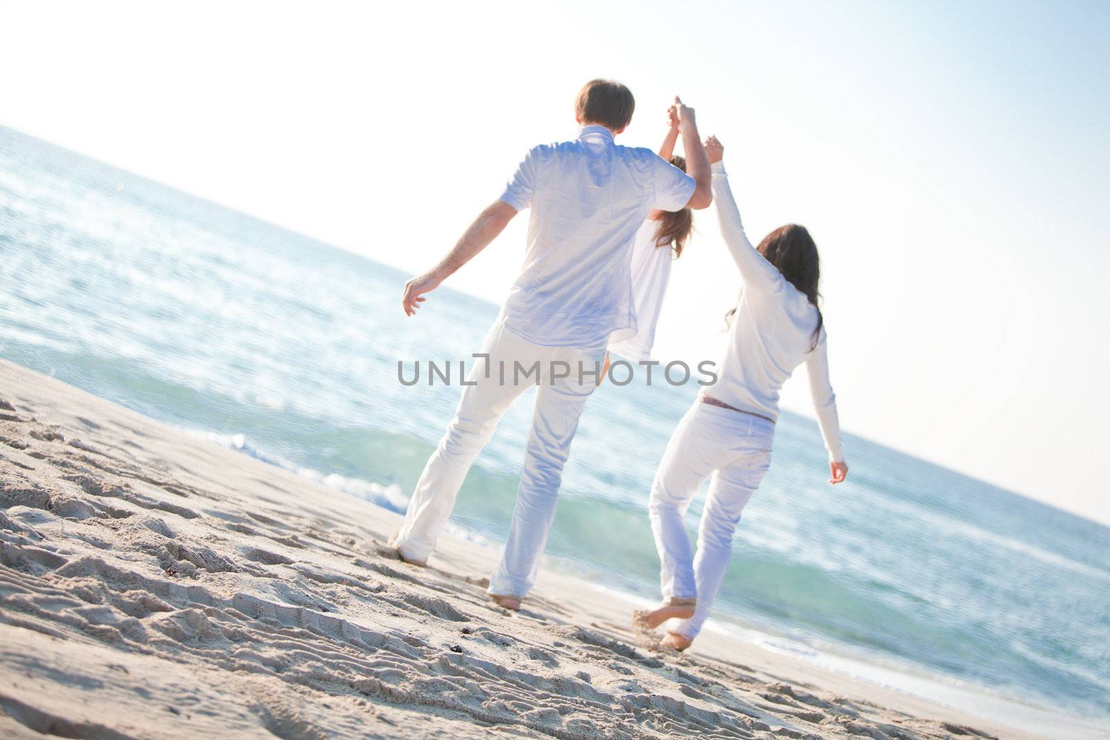 happy young family with daughter on beach in summer lifestyle