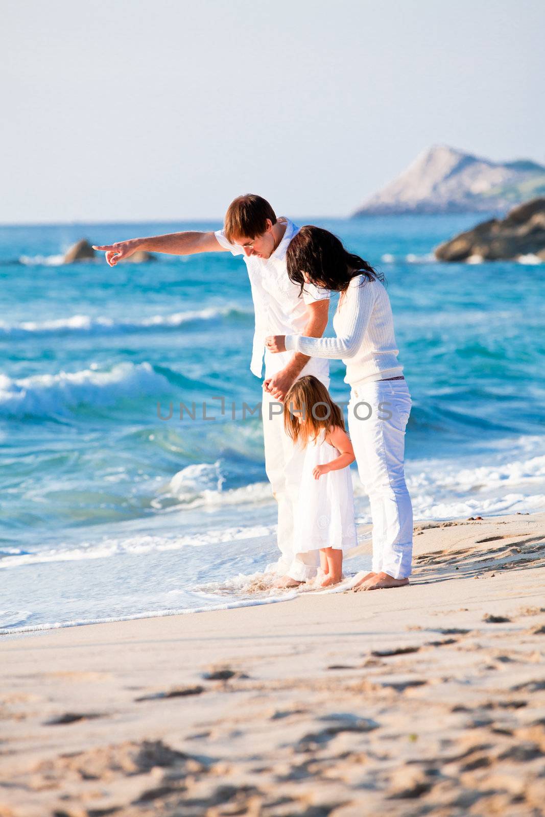 happy young family with daughter on beach in summer by juniart
