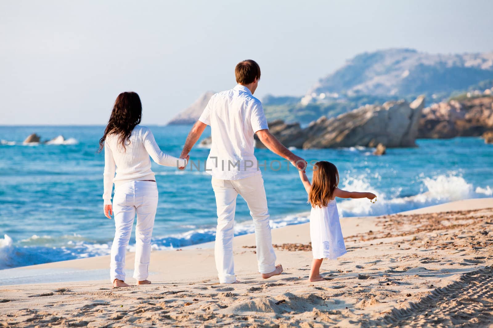 happy young family with daughter on beach in summer by juniart