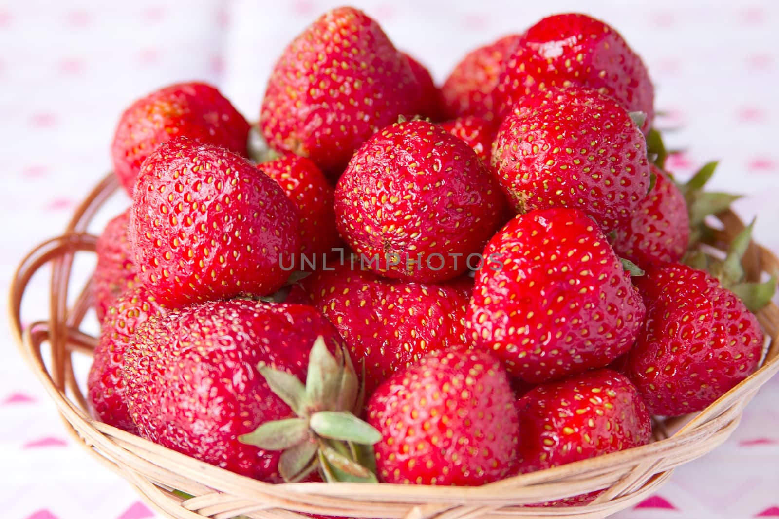 Fresh strawberries in a basket on a round table