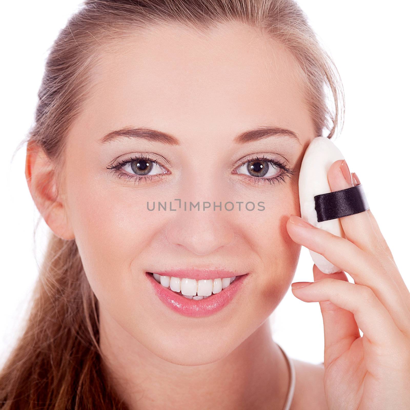 beautiful woman applying make up on face isolated on white