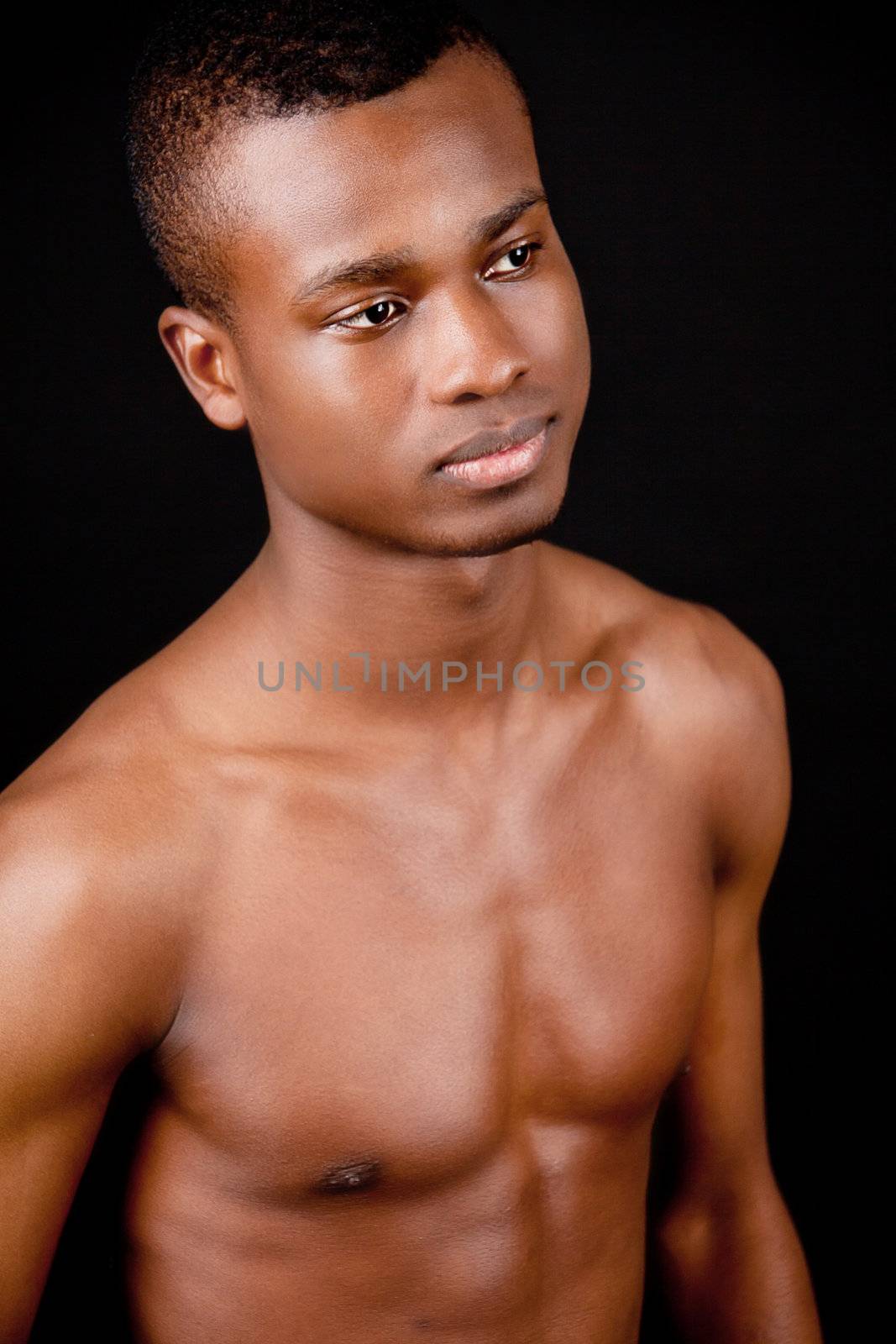 young african afro man with dark skin on black background