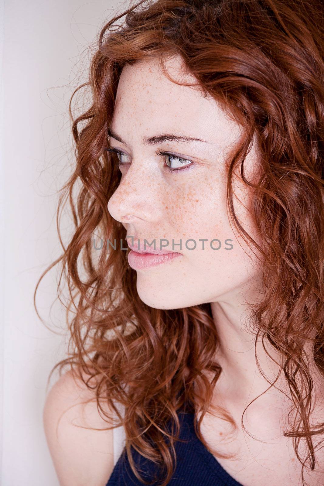 beautiful red head woman with freckled face and blue eyes