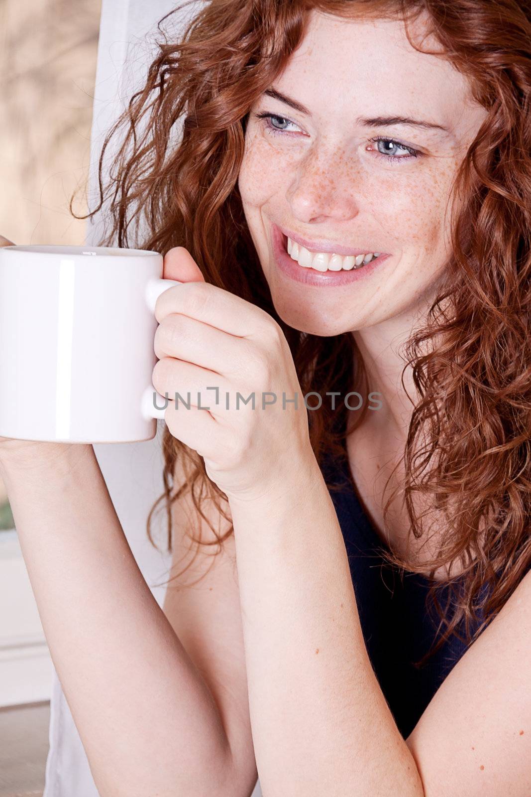 pretty young redhead woman with freckles and coffe smile and laugh