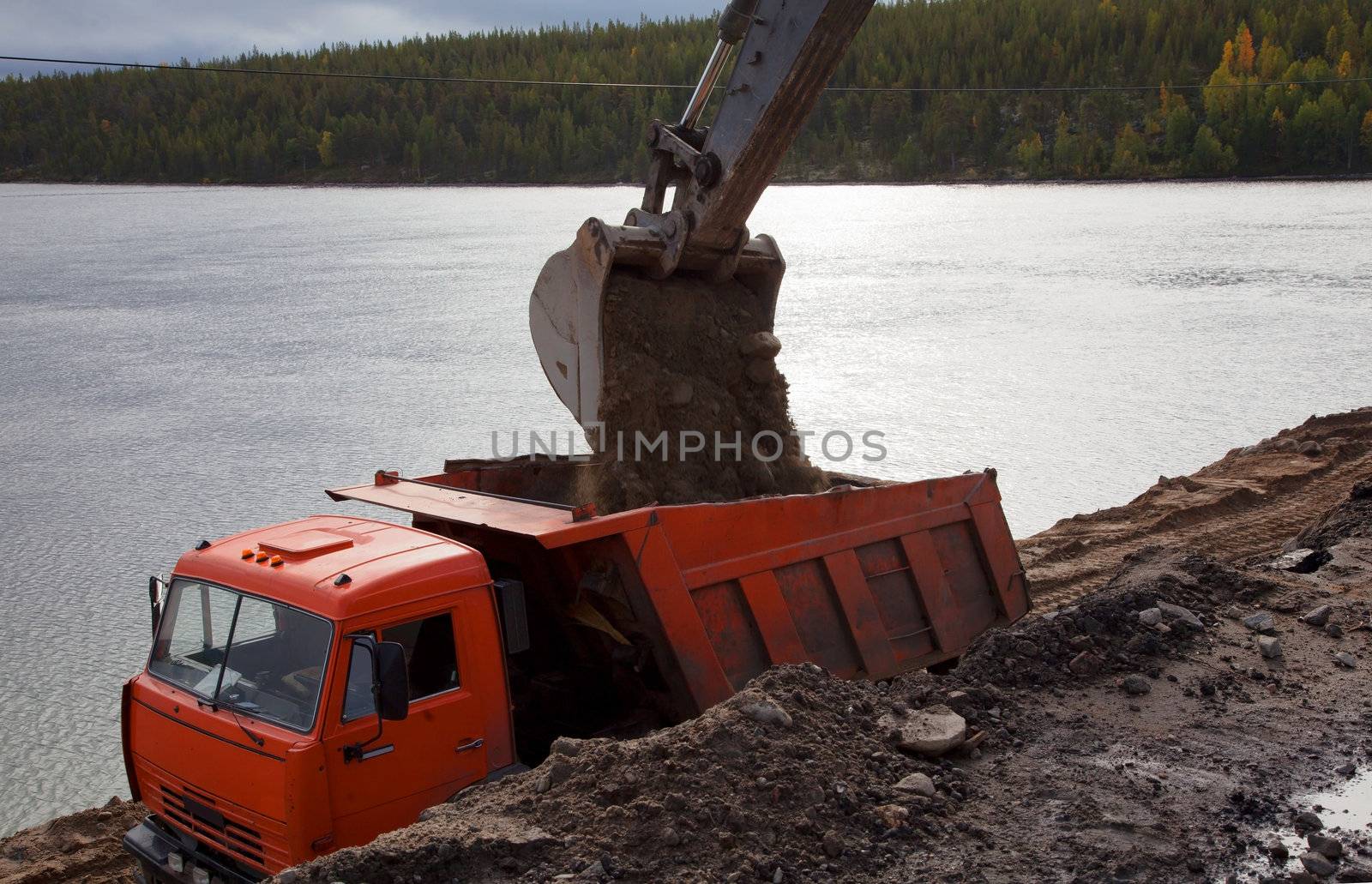 Construction of the road by the lake. Russia. North. taiga