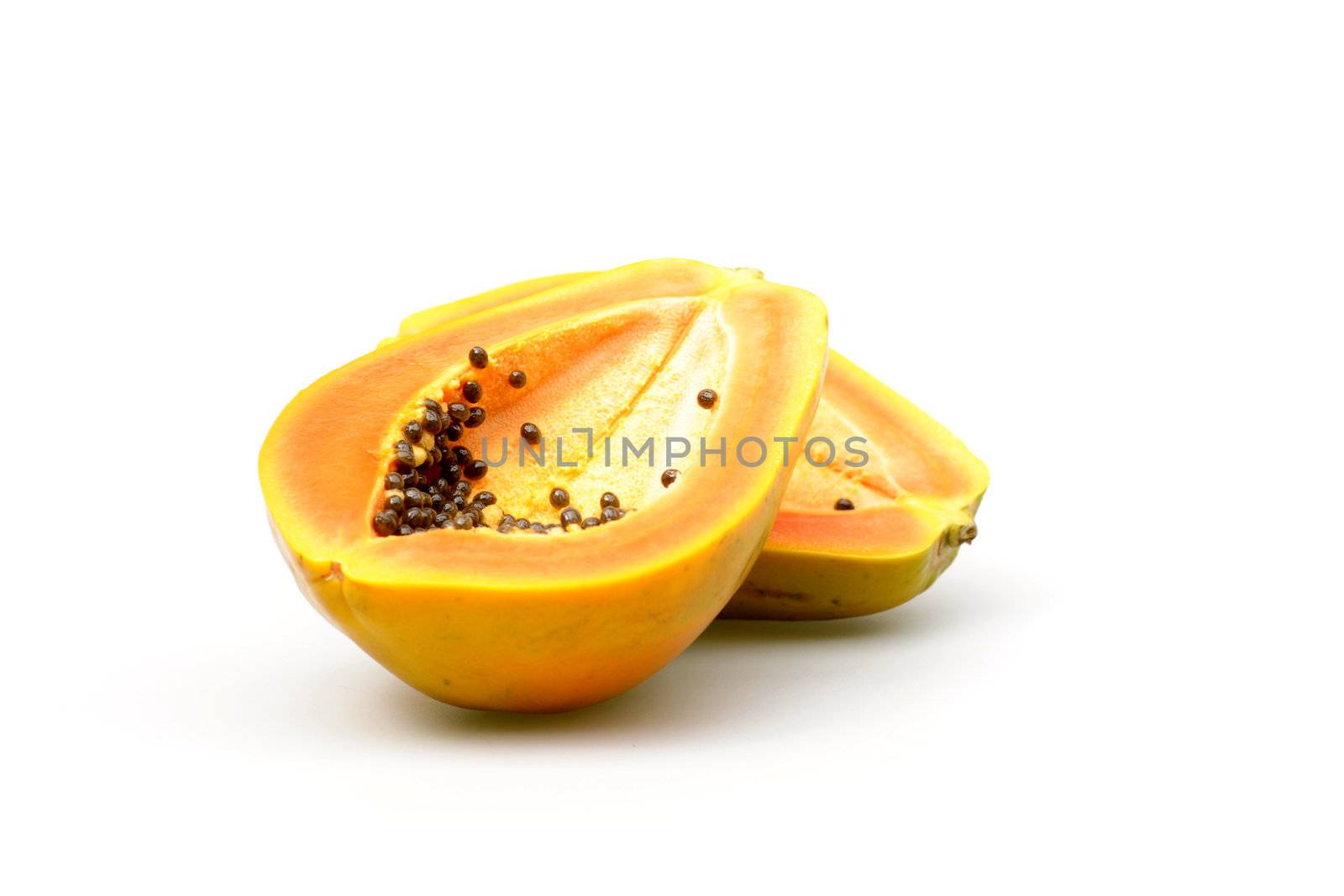 Ripe papaya cut in half photographed on a white background.