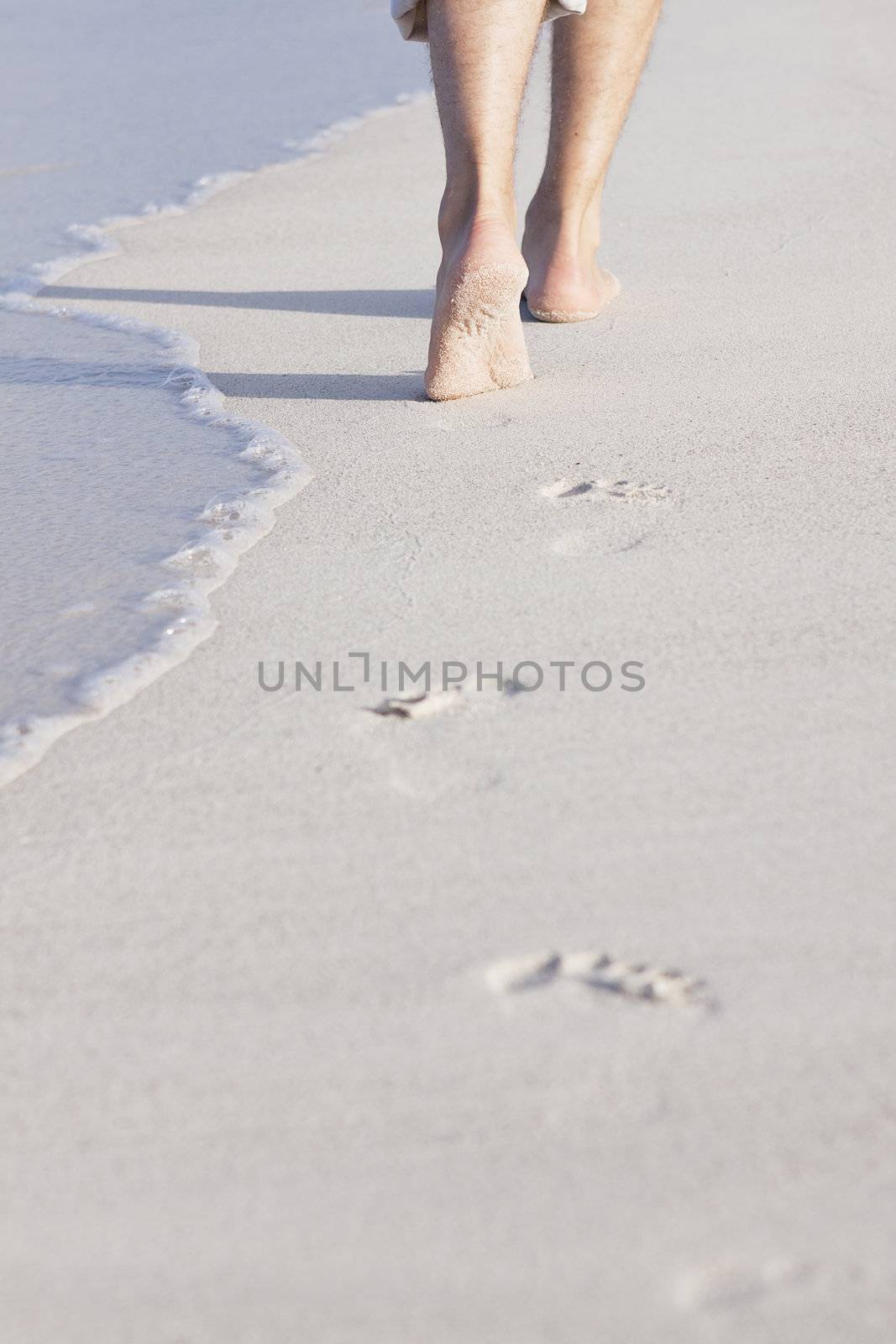 walking barefoot in the sand in summer holidays on beach