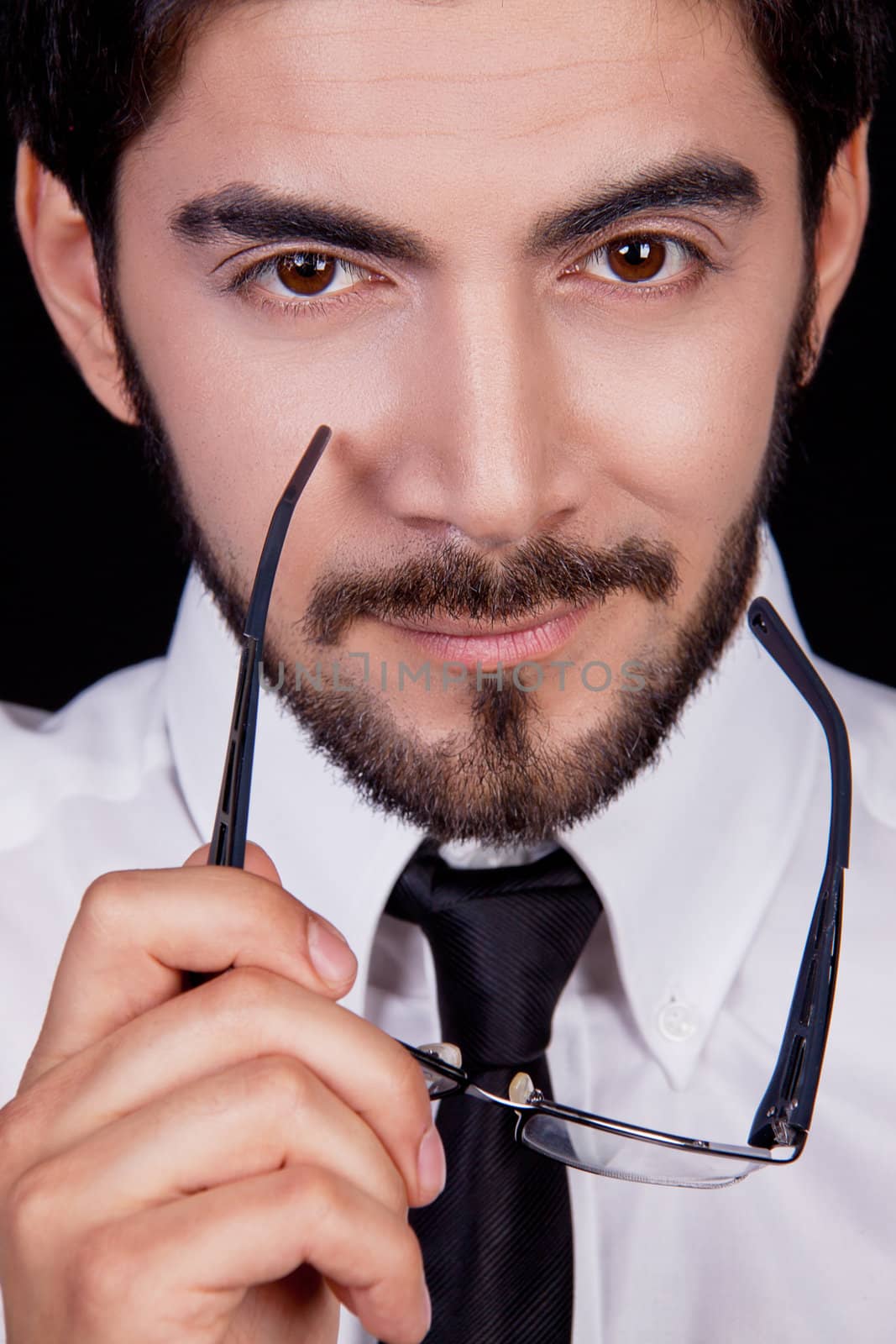 business man with tie and glasses and beard looking serious portrait