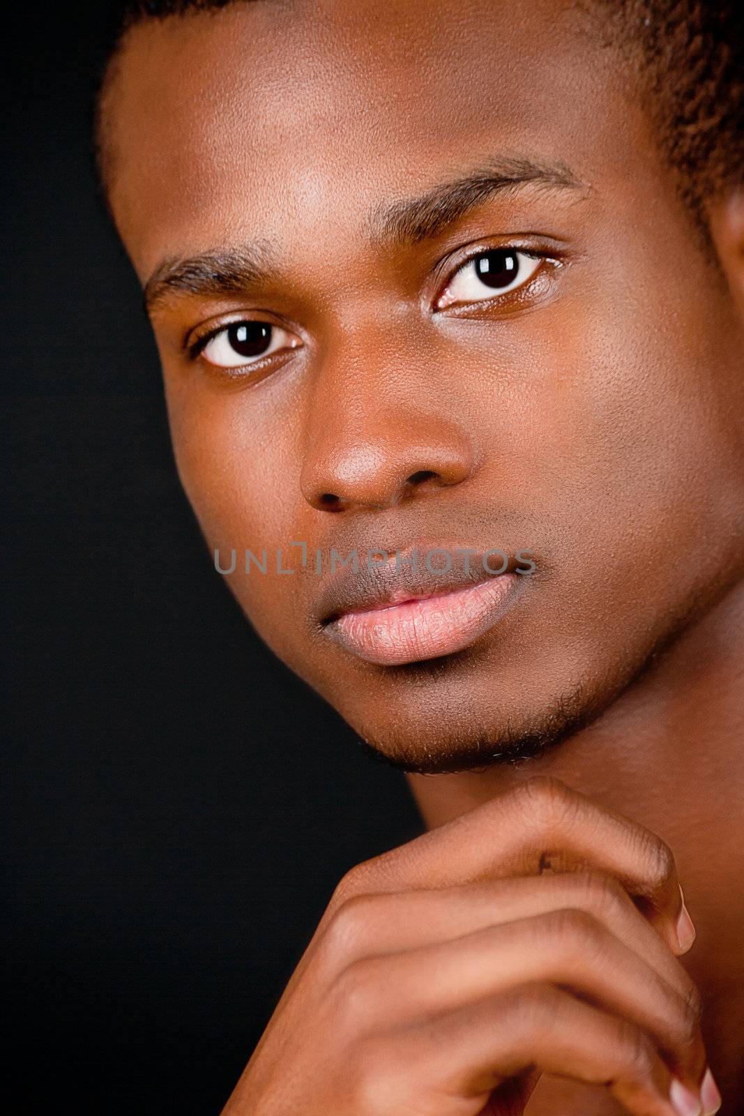 young african afro man with dark skin on black background