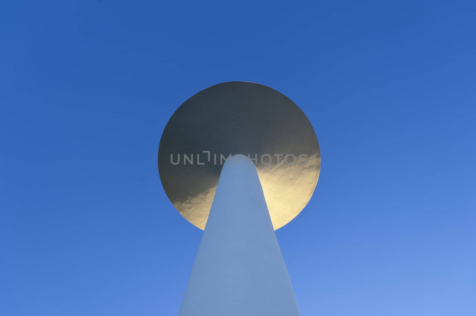 White painted water tower against a clear blue sky in the small village of S. Bartolomeu do Outeiro,  Alentejo, Portugal